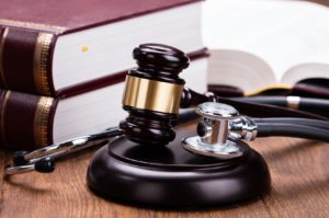 Medical-Malpractice-Lawyer-Oregon-scope-with-wooden-gavel.